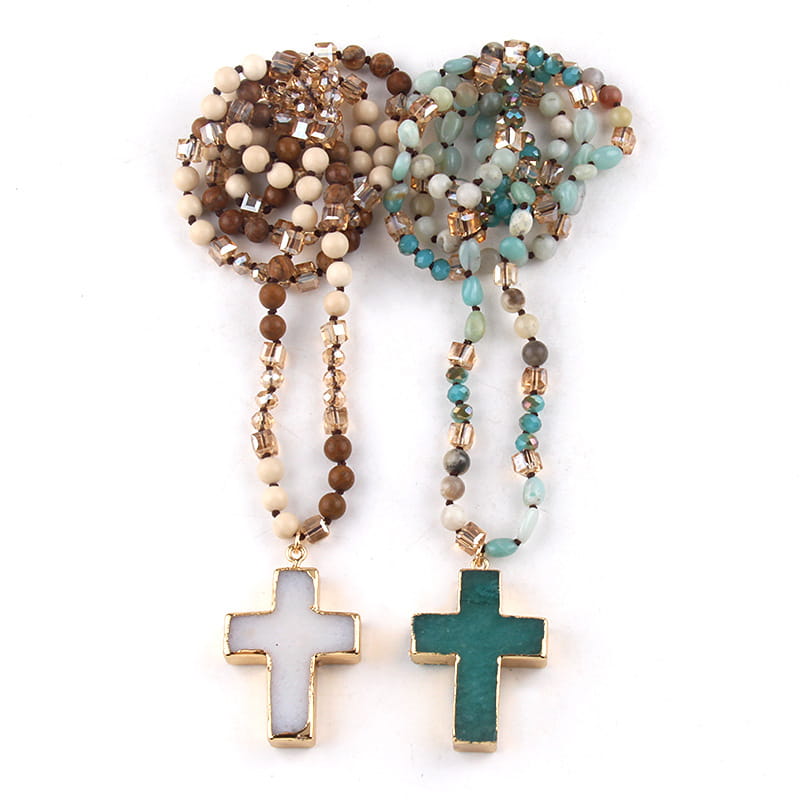 Two bohemian natural stone and glass beaded cross necklaces featuring one white cross pendant and one teal green cross pendant with mixed earth-toned beads and gold-tone accents.