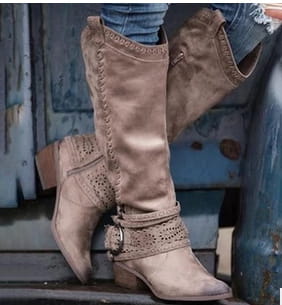 Women’s suede knight boots in tan with decorative stitching and a metallic buckle strap.