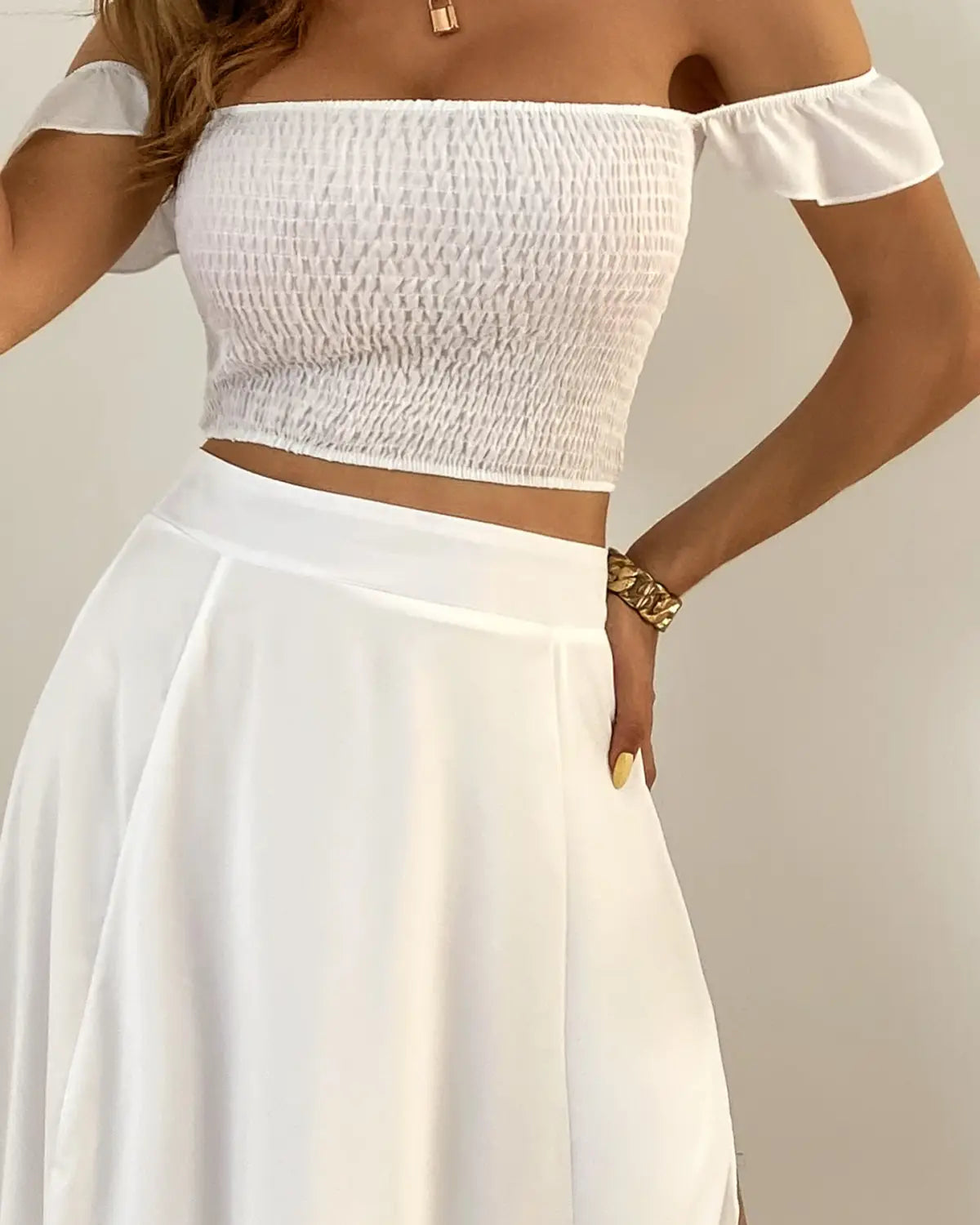 white off-the-shoulder smocked crop top with ruffled sleeves featured in a bohemian off-shoulder high slit two-piece maxi dress set