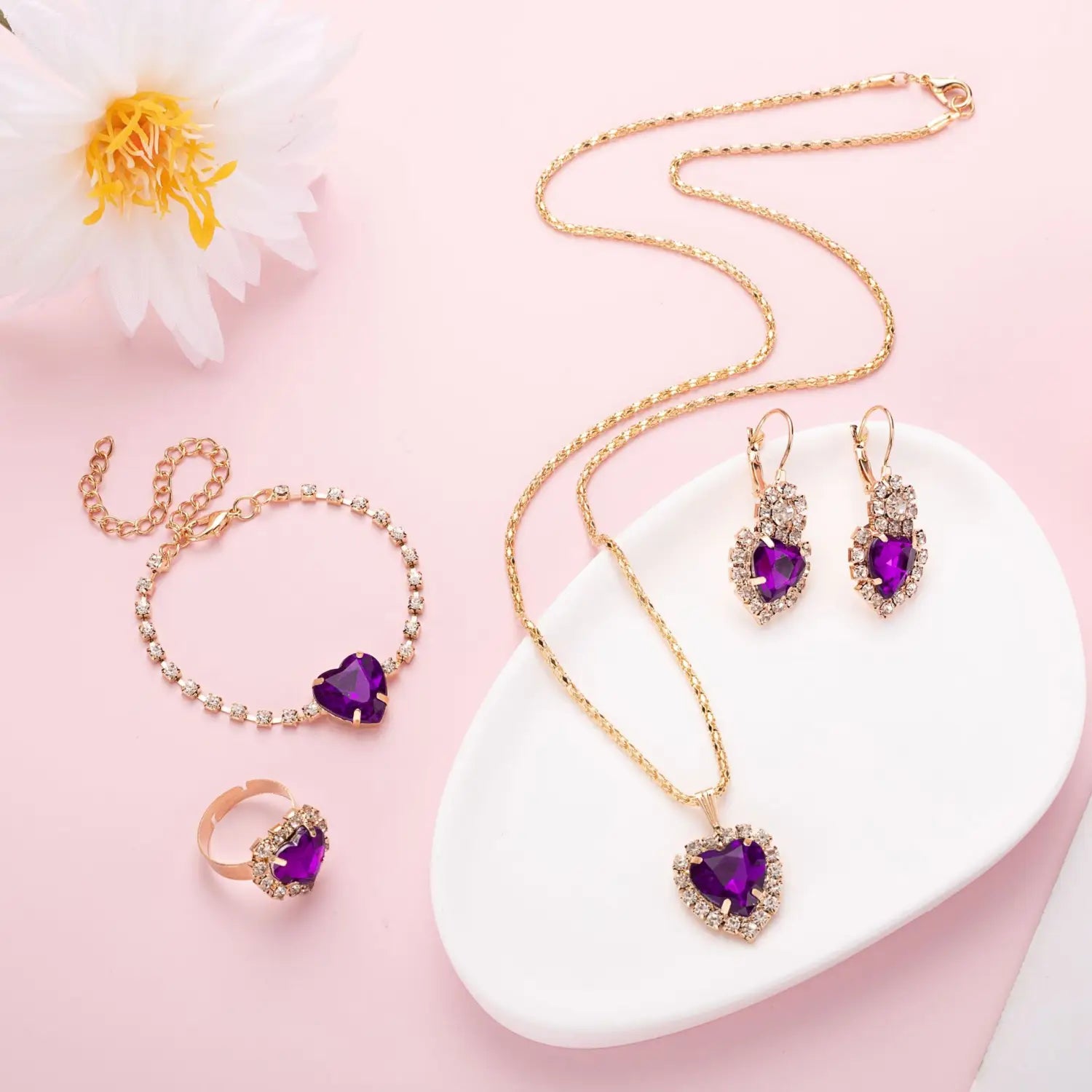 Gold-toned 4 piece heart rhinestone jewelry set featuring vibrant purple gemstones encircled by sparkling clear crystals.