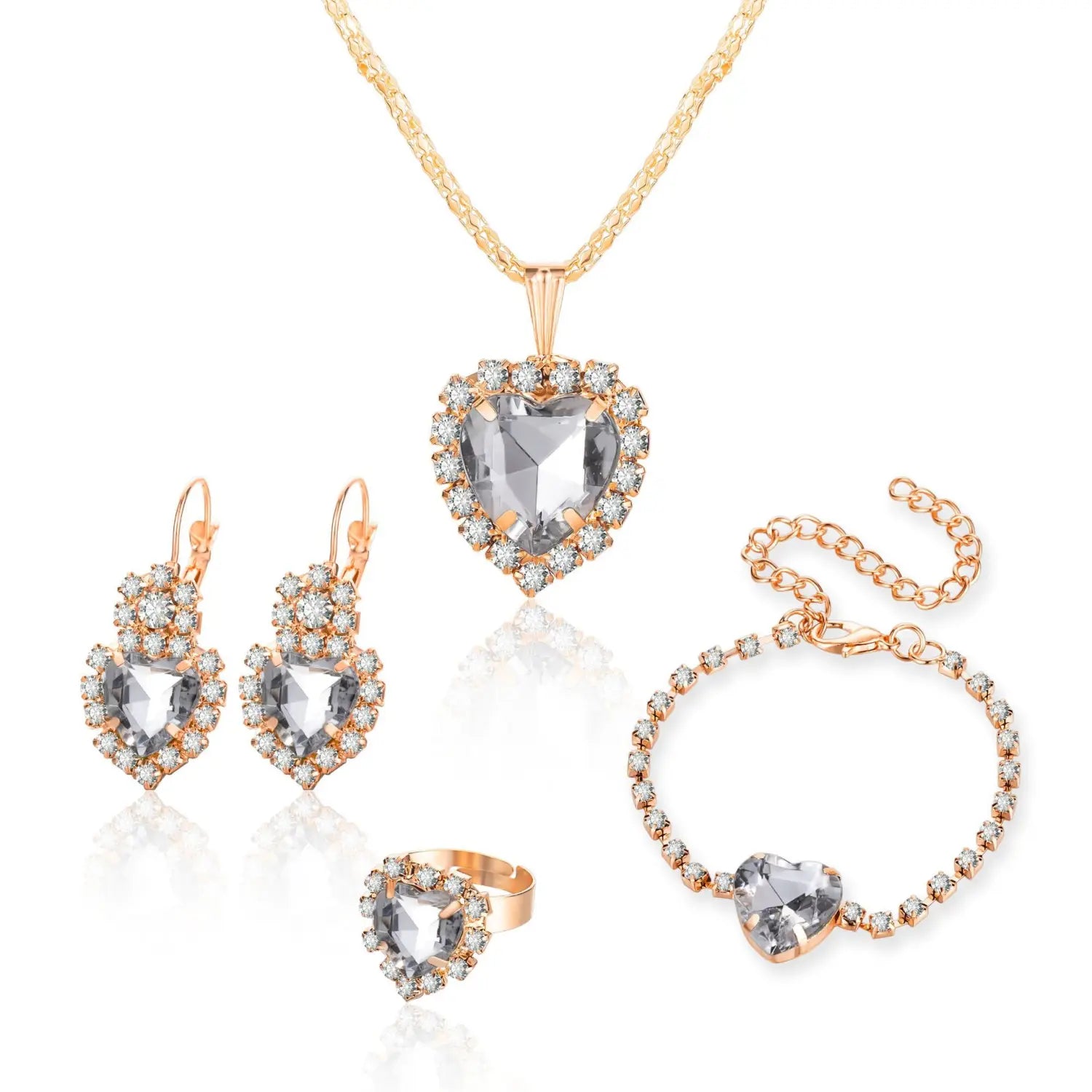 Rose gold 4 piece heart rhinestone jewelry set featuring a central clear crystal surrounded by smaller matching crystals on each piece.
