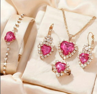 pink heart-shaped gemstone jewelry set with gold-tone metal and diamond accents in a 4 piece heart rhinestone jewelry set with matching crystals