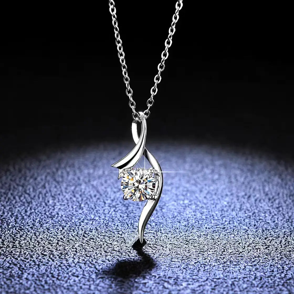 A delicate 925 sterling silver twisted necklace with a flowing curved pendant cradling a sparkling round-cut moissanite solitaire diamond.