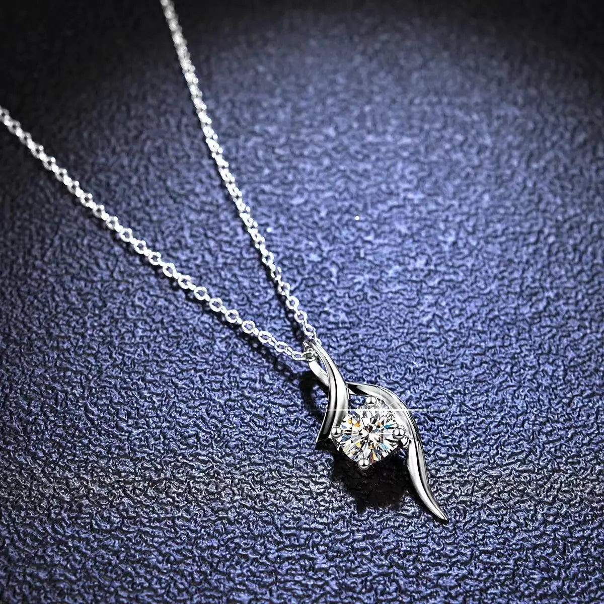 A delicate 925 sterling silver twisted moissanite solitaire necklace featuring a central round-cut diamond held by elegant flowing metal wings.