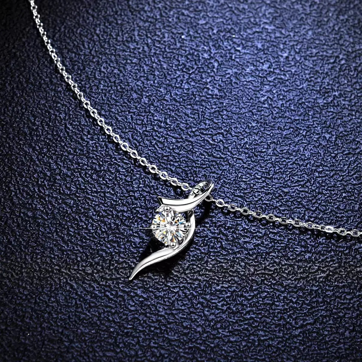 925 sterling silver twisted moissanite solitaire necklace featuring a delicate leaf-shaped pendant with a round-cut diamond.