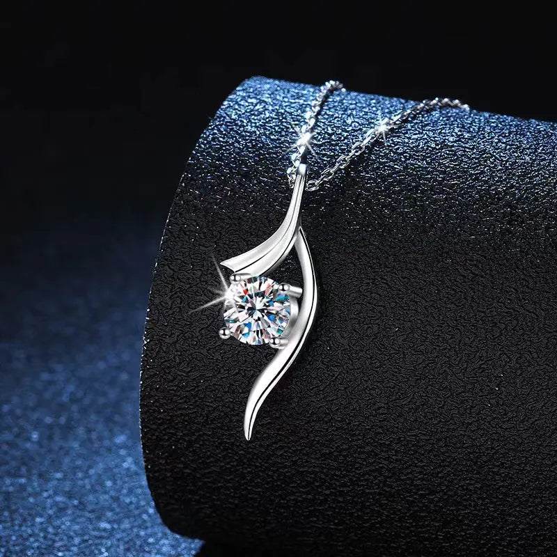 A silver 925 sterling silver twisted leaf-shaped pendant necklace with a central round-cut clear moissanite solitaire gemstone.