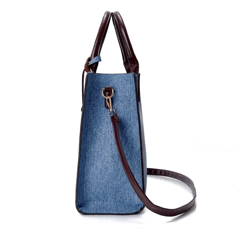 Denim blue handbag with brown leather handles and strap from the denim and leather three piece multi compartment handbag set.