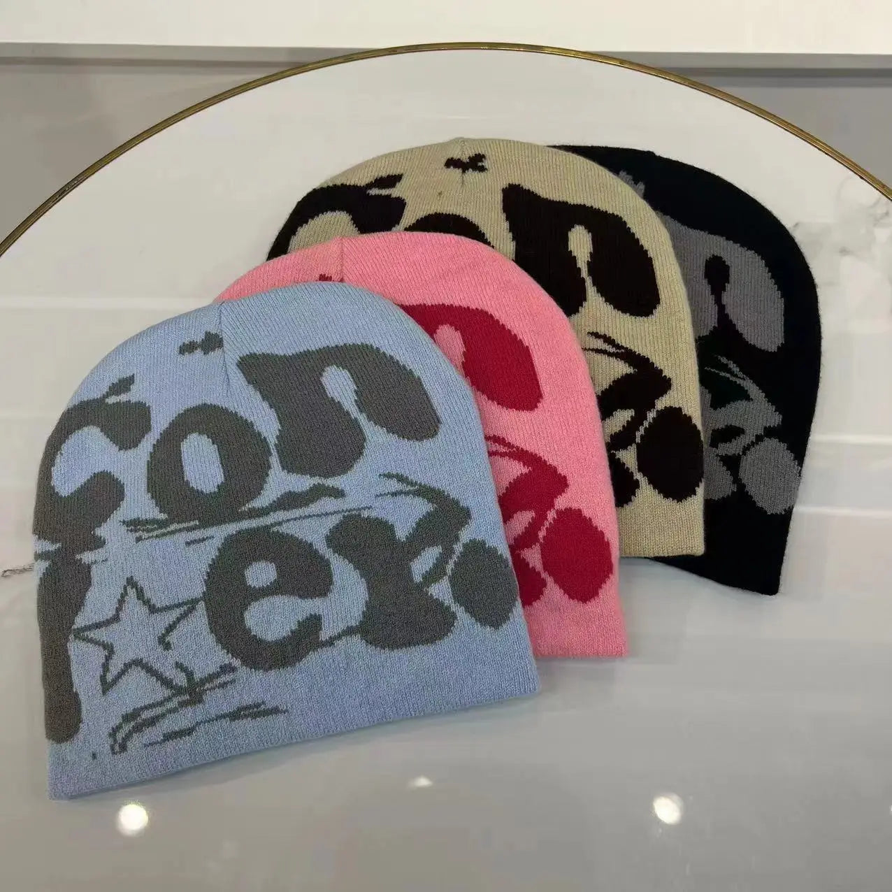 Light blue knitted letter jacquard beanie made of warm knit material featuring bold gray converse lettering and a star graphic for winter use.