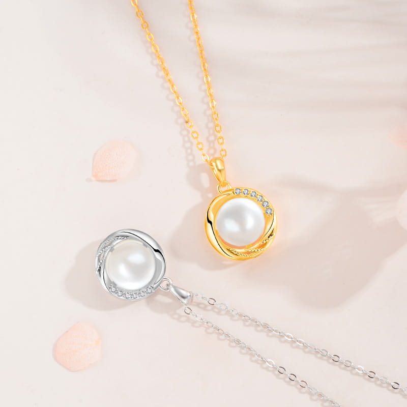 Sterling silver round freshwater pearl pendant necklaces in gold-tone and silver-tone with elegant halos of clear stones.