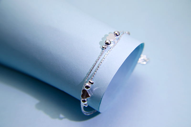 Delicate korean double layer silver heart bead anklet featuring a chain with small spherical beads and heart-shaped charms.