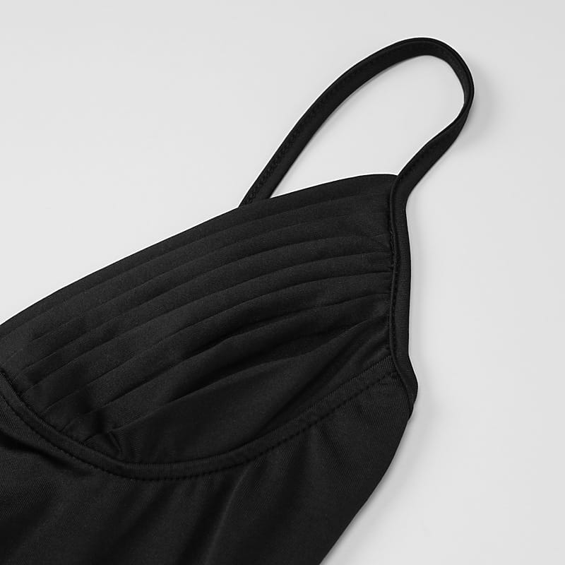 black quilted spaghetti strap top with a structured fitted bodice paired with satin deep v neck backless midi dress with side slit shown from the back