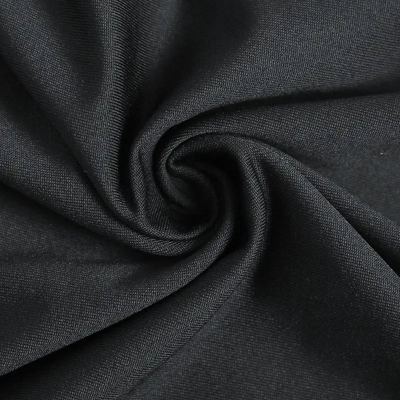black textured fabric with a subtle woven pattern on a v neck long sleeve ruched slit maxi dress