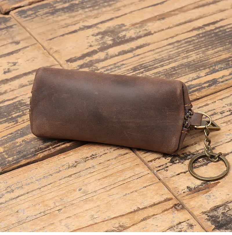 Brown leather premium cowhide leather multi-functional key and coin pouch with zipper closure and metal ring.
