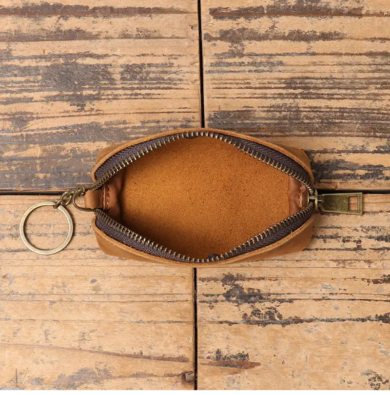 Premium cowhide leather multi-functional key and coin pouch in tan with a dark zipper and metal key ring.