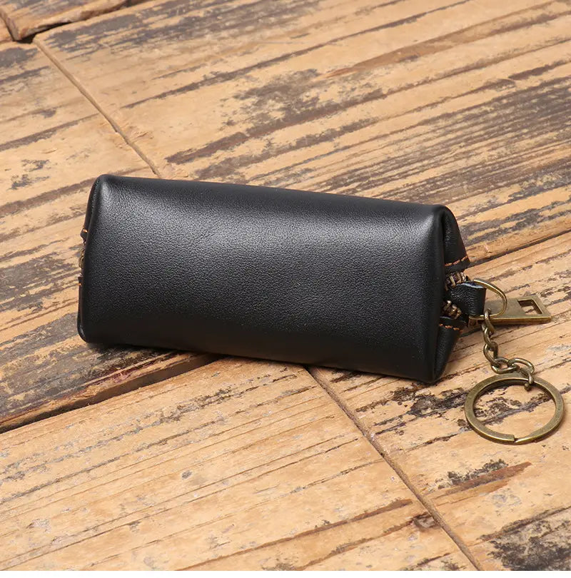 Black leather premium cowhide multi-functional key and coin pouch with brass-colored metal ring and zipper pull.