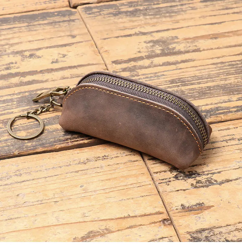 Brown leather premium cowhide multi-functional key and coin pouch with zipper closure and brass-colored metal hardware.