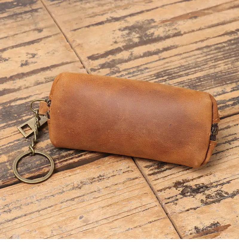 A tan premium cowhide leather multi-functional key and coin pouch with a zipper closure and metal ring attachment.