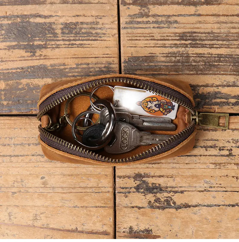 Premium cowhide leather multi-functional key and coin pouch in tan leather with a dark brown zipper and brass pull.