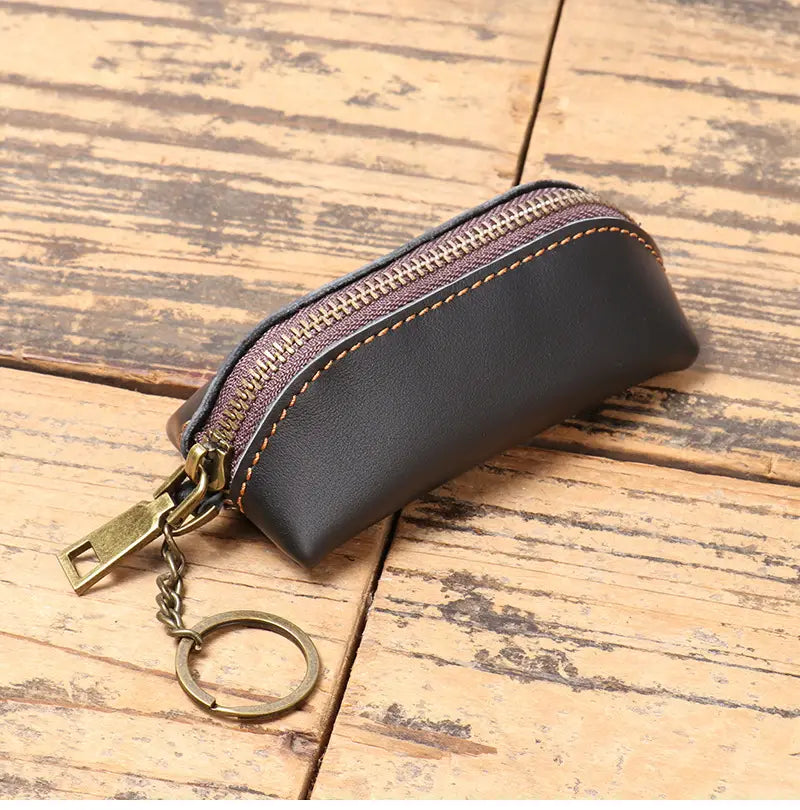 Black leather premium cowhide leather multi-functional key and coin pouch with a brass zipper and matching chain.