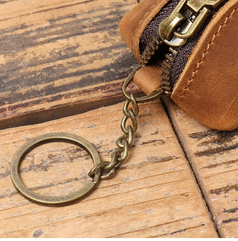 Premium cowhide leather multi-functional key and coin pouch in tan with an antique brass keychain attached to a matching zipper coin purse.