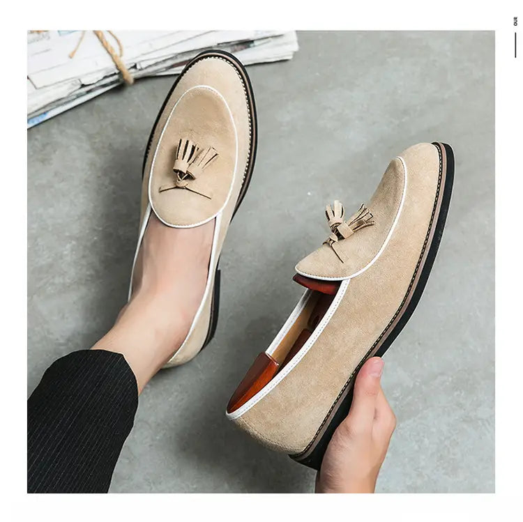 Beige men’s suede tassel loafer made of matte cowhide with white stitching.