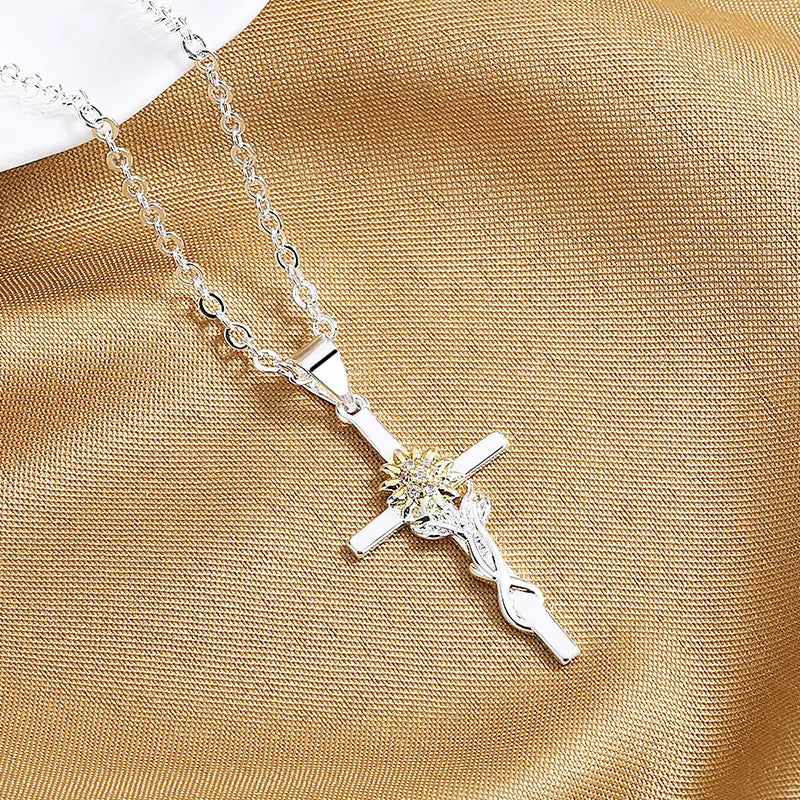 two-tone silver and gold sunflower cross pendant necklace with a silver cross featuring a delicate chain and an ornate crucifix design adorned with sparkling gemstones