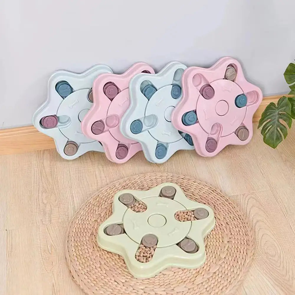 Pastel-colored star-shaped interactive dog puzzle toy and slow feeder with multiple slots and a central hub for training and feeding.