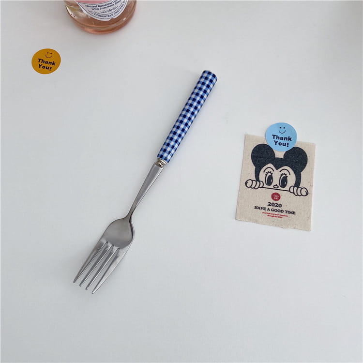 blue and white checkered handle fork with stainless steel shaft from a checkered stainless steel cutlery tableware set