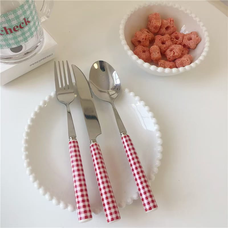 Red and white checkered handle cutlery set with stainless steel blades designed for tableware use.