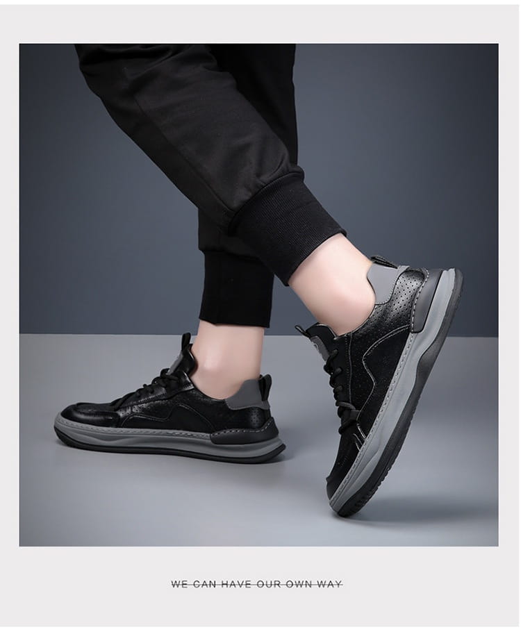 Black and gray men’s leather perforated breathable sneakers with a chunky sole displayed from the front angle.