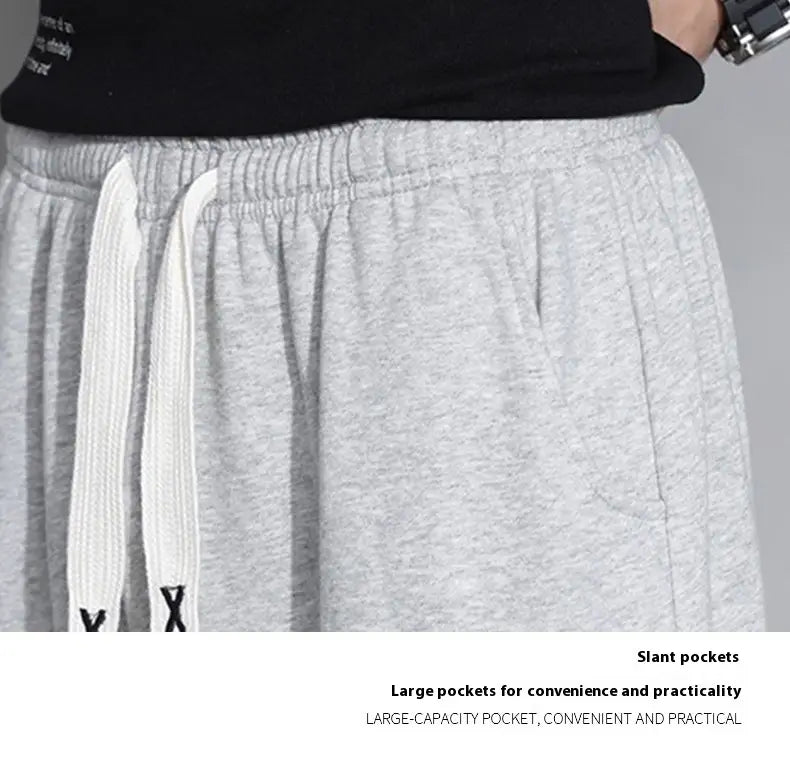 Men astronaut graphic joggers casual pants in gray heathered fabric with white drawstrings and slant pockets.
