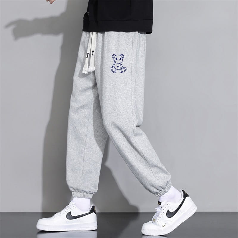 Men astronaut graphic joggers casual pants in gray cotton with white drawstrings and a small embroidered bear on the thigh.