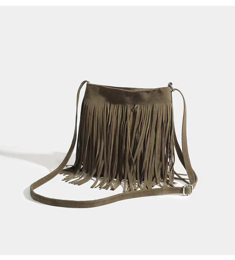 A maroon suede fringe crossbody bag with a long adjustable strap for artistic tassel canvas shoulder bag travel use.