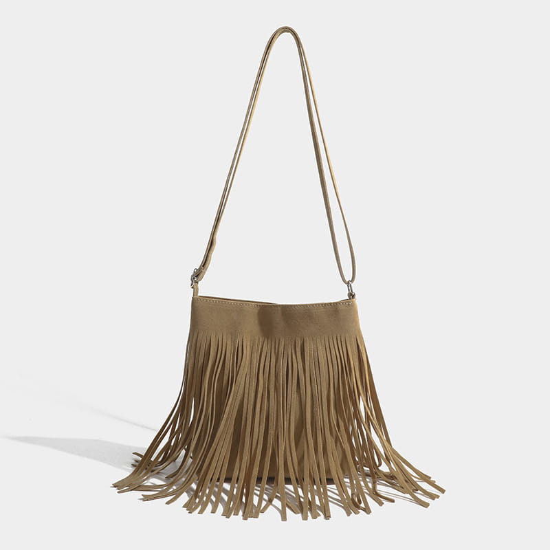 A maroon suede fringe crossbody bag with a long adjustable strap for artistic tassel canvas shoulder bag travel use.