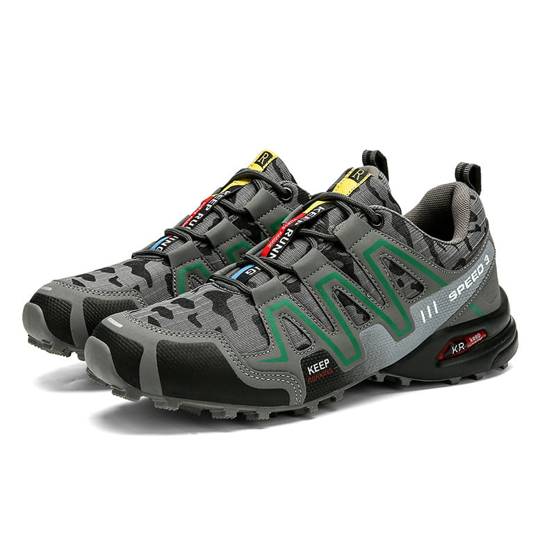 Men’s camouflage waterproof trail running and hiking shoes featuring gray and black camouflage pattern salomon speedcross 3 with green accents.