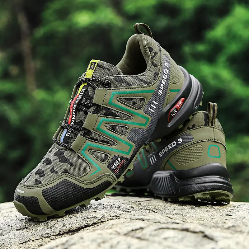 Men’s camouflage waterproof trail running and hiking shoes in olive green and black with teal accent stripes featuring a durable mesh upper and rubber outsole.