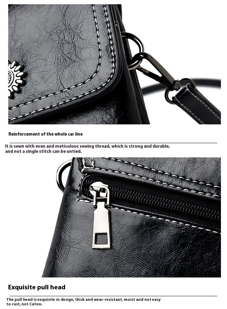 Schwarze Umhängetasche für das Telefon aus Kunstleder mit floralen und Sonnenstrahl-Details, mit weißer Ziernaht und einem silberfarbenen Reißverschlussanhänger.
