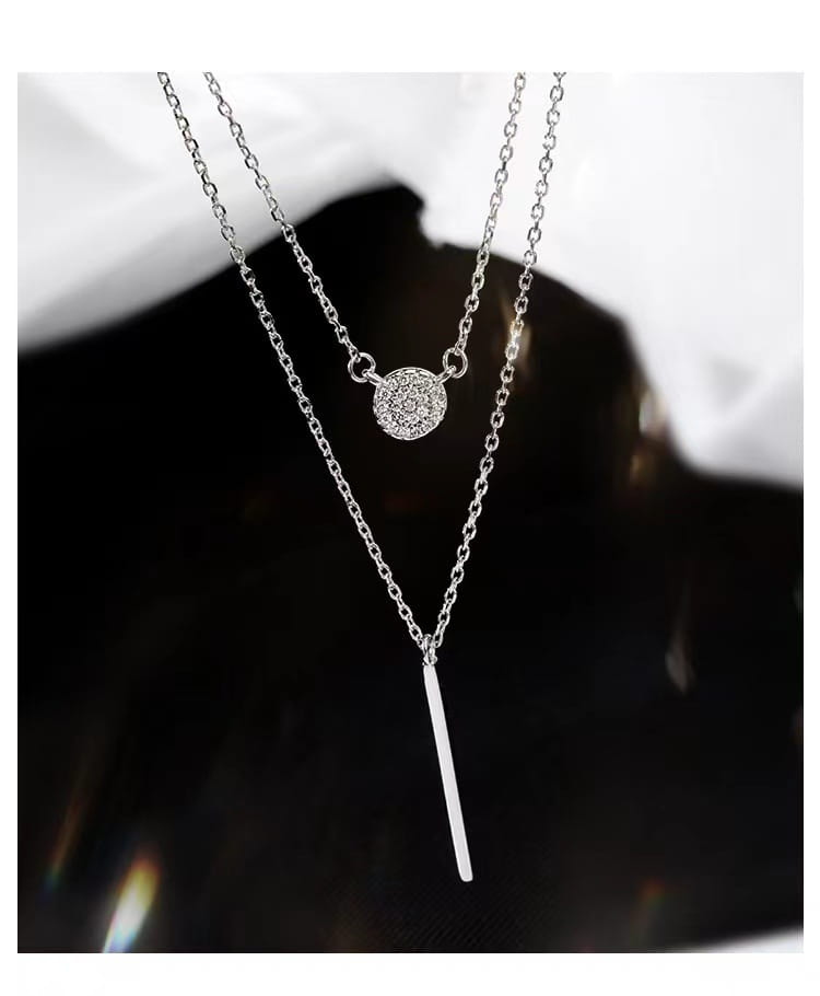Double layer silver pave zircon necklace featuring a round diamond pendant and a sleek vertical bar charm.