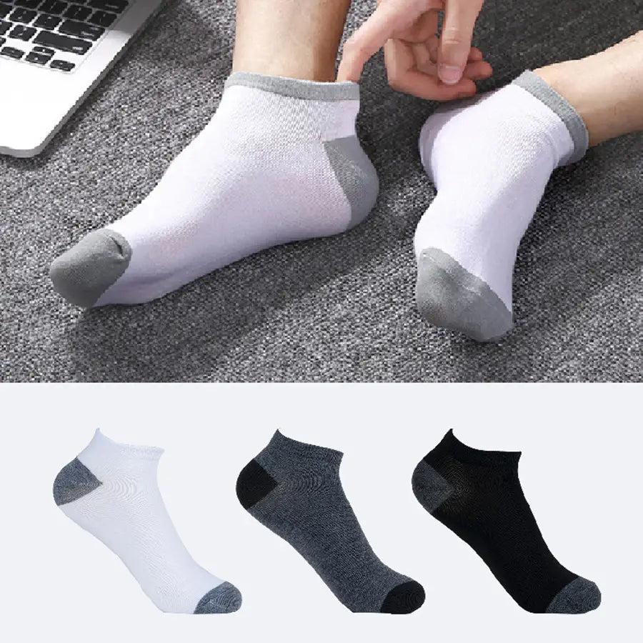 Men low cut white and gray ankle socks with textured knit design and reinforced toe and heel for durability and sweat absorbent athletic use.