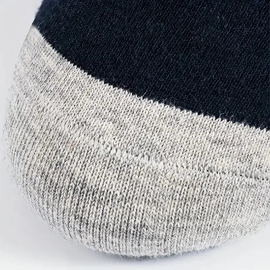 A close-up of men low cut socks sweat absorbent athletic ankle socks with a two-tone design featuring a dark navy upper section and heather gray toe area.