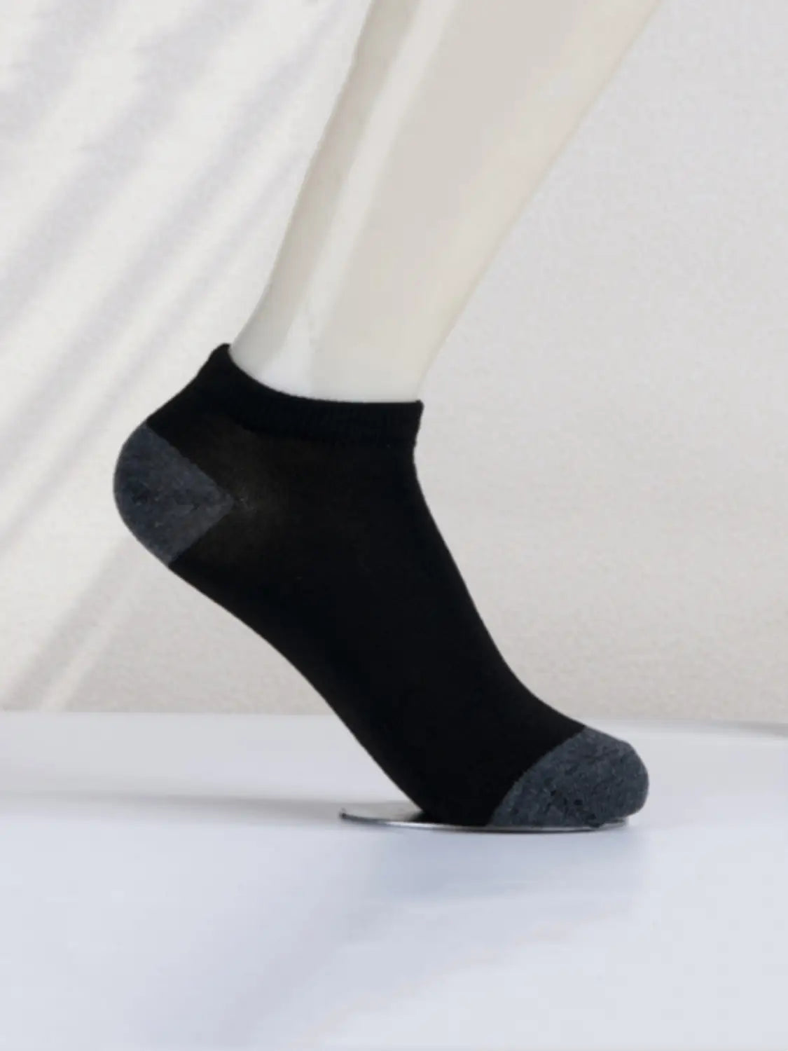 Black men low cut ankle sock with gray reinforced toe and heel designed for sweat absorbent athletic use.