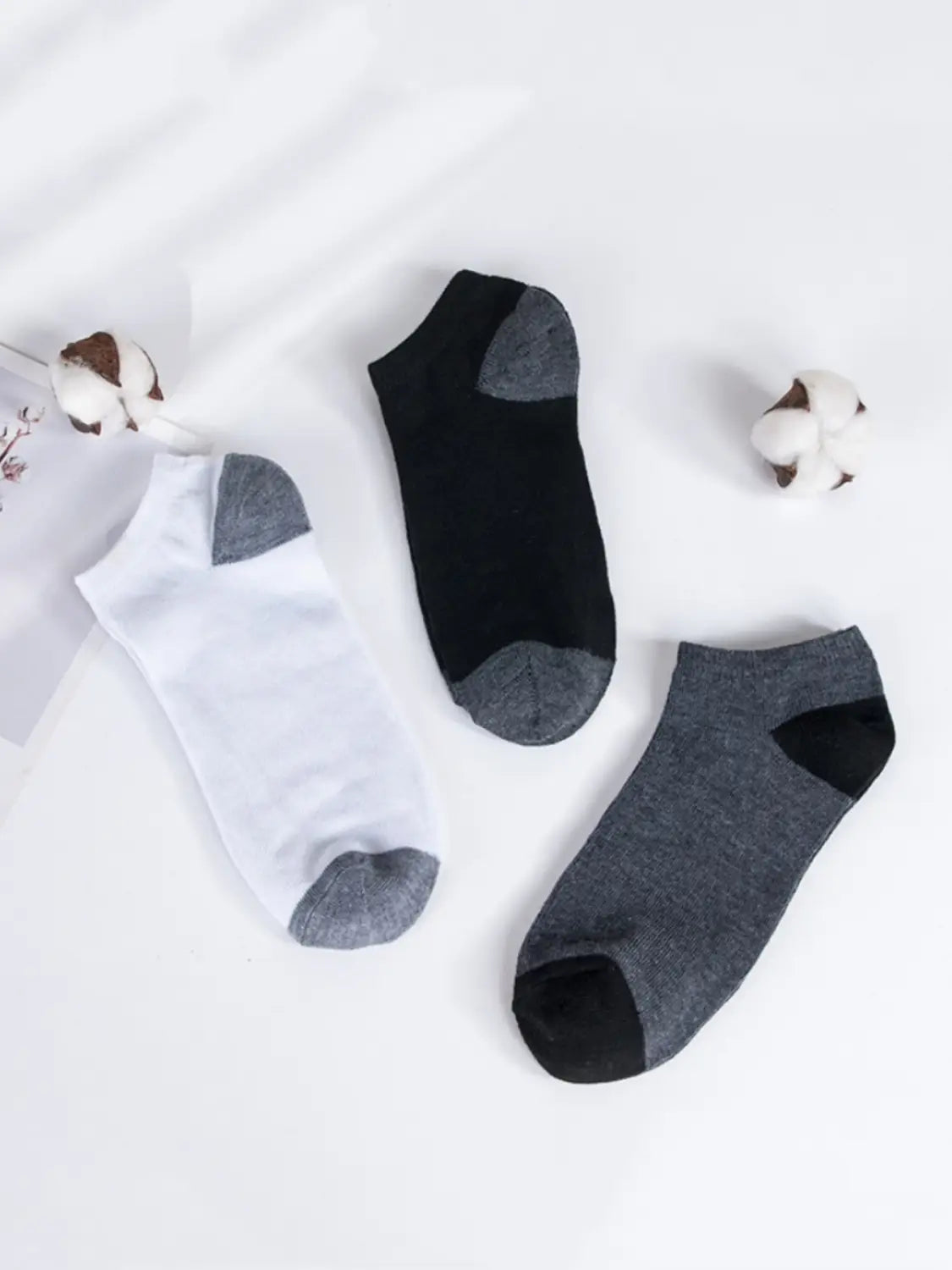 men low cut socks in white black and heather gray with contrasting toe and heel sections designed for sweat absorbent athletic use