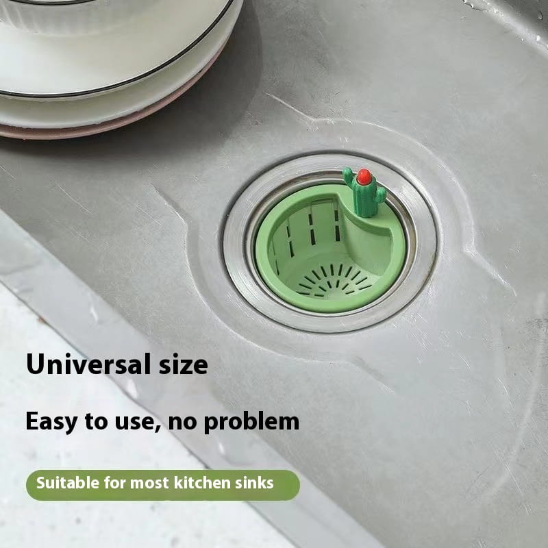 Green cactus-shaped plastic sink drain strainer basket filter net with a red top designed for kitchen sink use.
