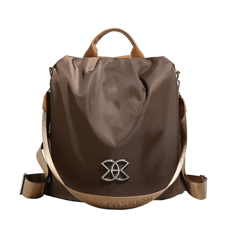Brown nylon waterproof large capacity travel backpack with tan pu leather handles and straps and a silver metallic logo on the front.