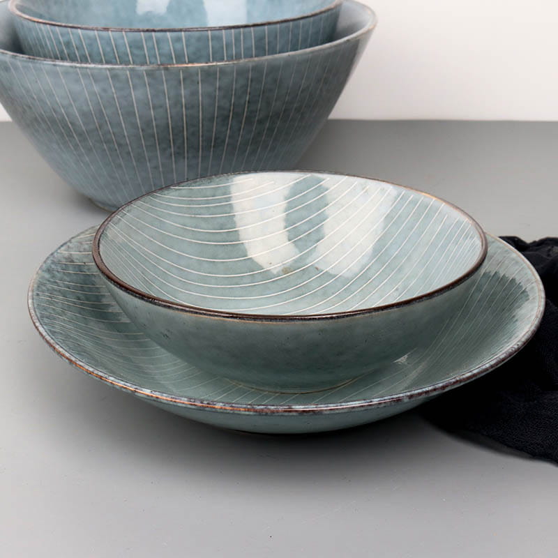 Set of three teal ceramic bowls with matte finish subtle white radial lines and rustic brown rims from the ceramic dinnerware set retro ribbed plates and bowls.