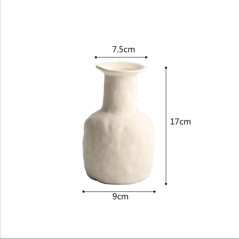 A minimalist off-white ceramic vase with a textured slightly uneven surface and a slender neck suitable for Scandinavian textured pottery decor.