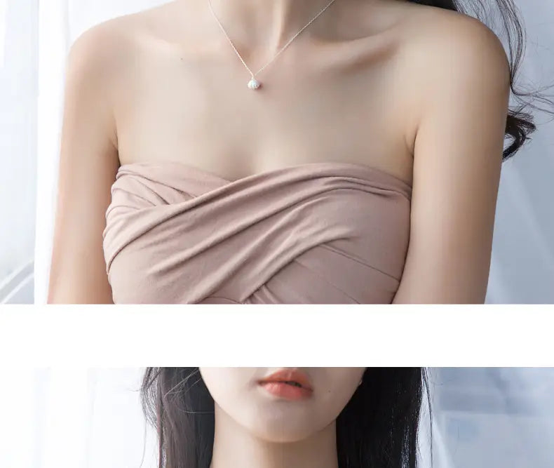 A delicate personalized s925 silver necklace featuring a single white pearl pendant designed as a shell.