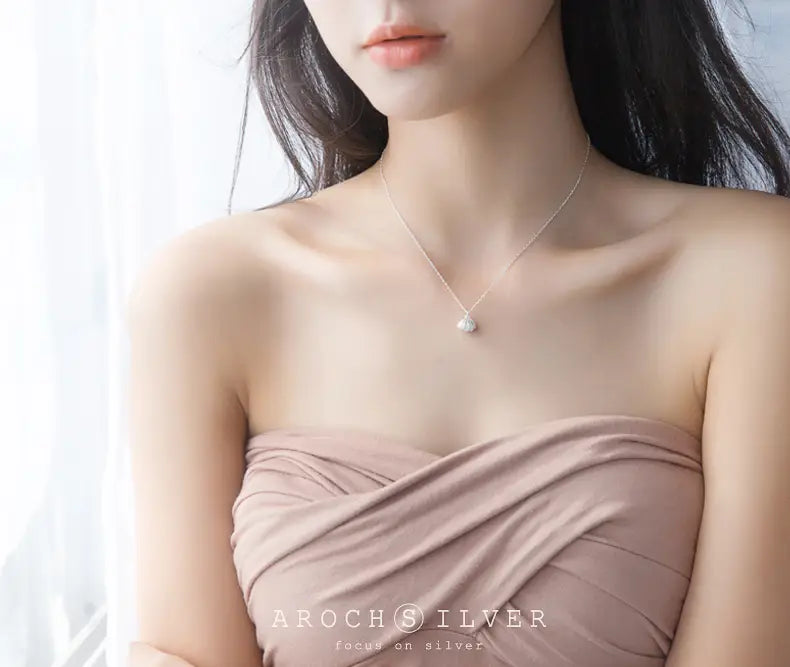 A delicate personalized s925 silver necklace featuring a small round pearl pendant.