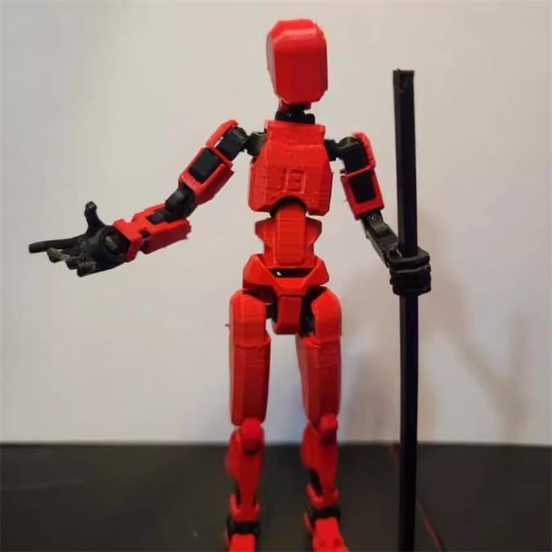 黒色の関節および手を備え、細身のポールを保持している赤色の3Dプリント関節可動ロボットアクションフィギュア用ダミー 2.0。