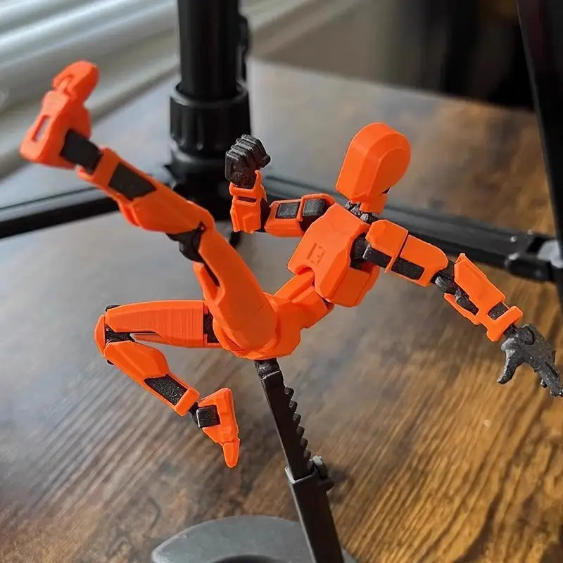 ダイナミックな空中ポーズで、黒色の関節ディテールを備えたオレンジ色の3Dプリント関節可動ロボットアクションフィギュア用ダミー 2.0。